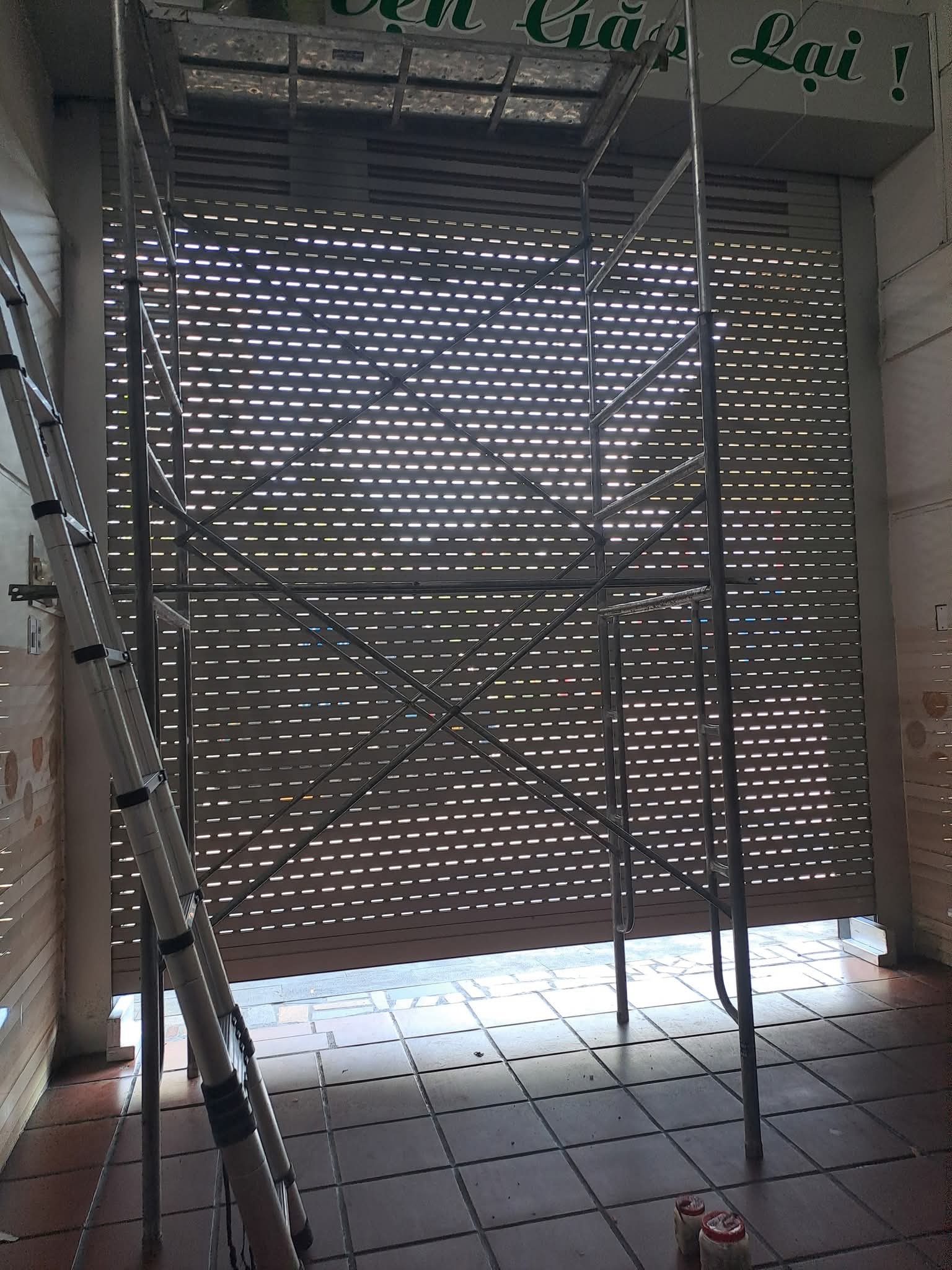Thợ sửa cửa cuốn đang kiểm tra hộp điều khiển tại Thanh Xuân